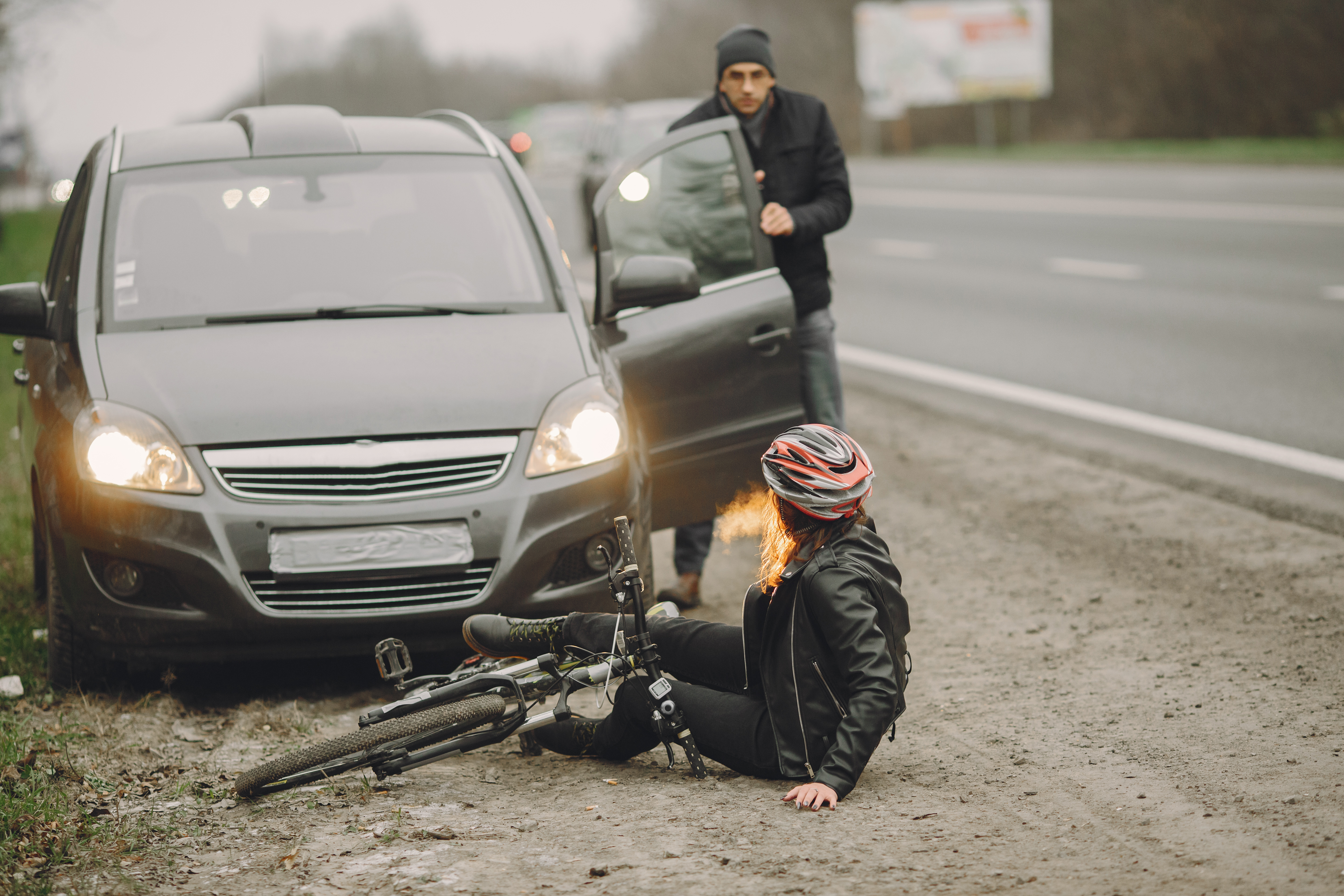 Car accident scene with an attorney speaking to an injured driver